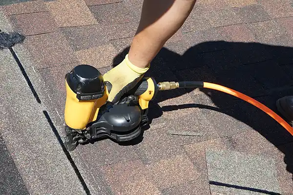 Roofer installing new shingles